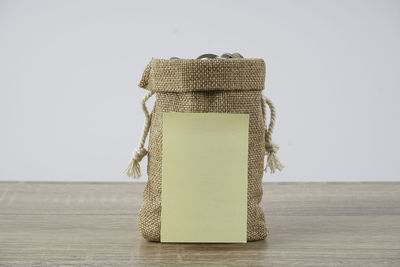 Close-up of wicker basket on table against white background