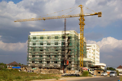 Construction site by building against sky