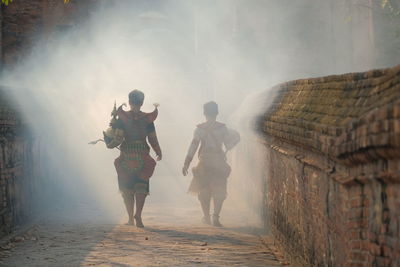 Rear view of people walking outdoors