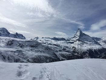 Scenic view of snowcapped mountains against sky