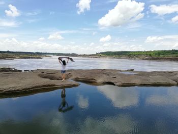 Man standing on beach against sky