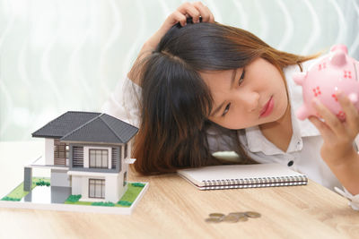 Portrait of girl on table at home