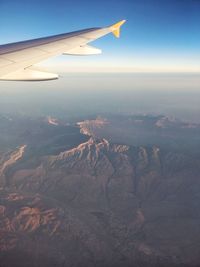 Aerial view of airplane flying over landscape