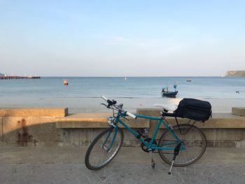 Bicycles on beach against sky