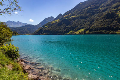 Scenic view of lake and mountains against sky