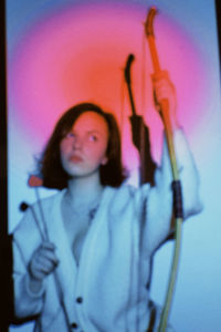 Portrait of woman with arms raised