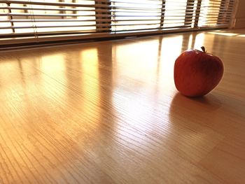 Close-up of apple on wooden floor
