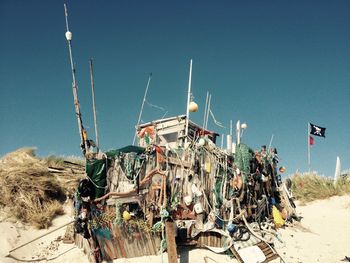 Panoramic view of garbage at beach against clear blue sky