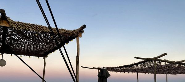 Low angle view of birds on roof against sky