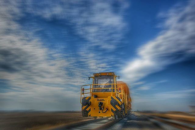sky, cloud - sky, transportation, yellow, cloudy, cloud, mode of transport, field, landscape, outdoors, no people, sunset, land vehicle, day, nature, rural scene, agriculture, blue, tranquility, sand