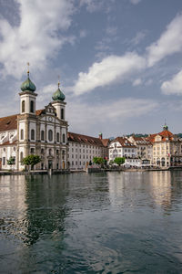 Canal amidst buildings in city against sky