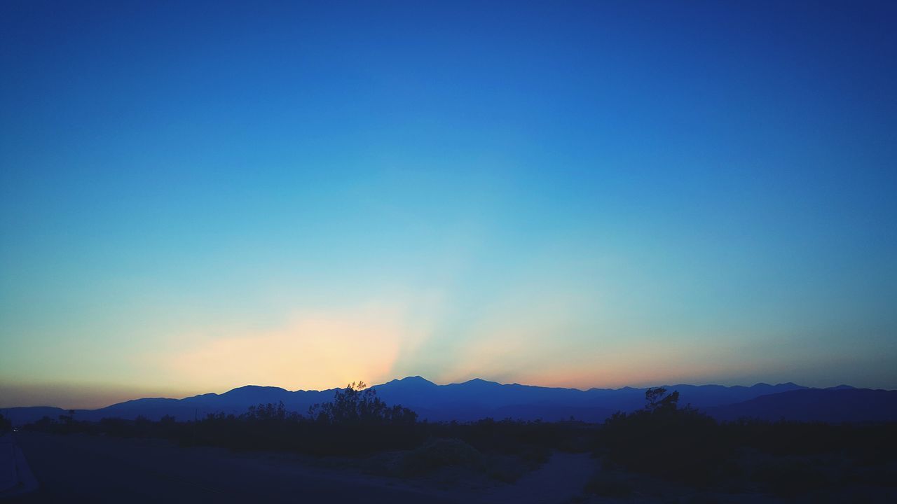 mountain, tranquil scene, scenics, tranquility, beauty in nature, landscape, blue, mountain range, nature, sunset, idyllic, non-urban scene, sky, remote, majestic, outdoors, horizon over land, no people, non urban scene, physical geography, travel destinations, hill, tourism