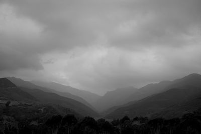 Scenic view of mountains against dramatic sky