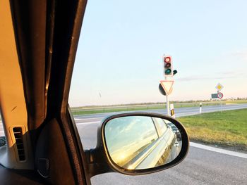 Close-up of road seen through side-view mirror