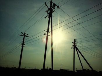 Low angle view of electricity pylon against sky