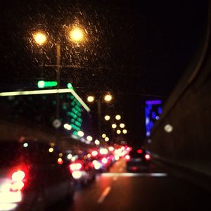 Defocused image of illuminated city street at night