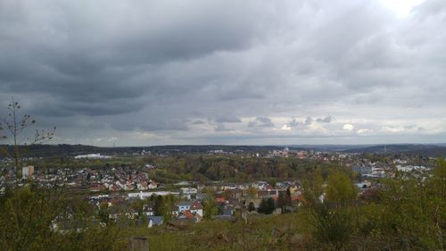 View of cityscape against cloudy sky