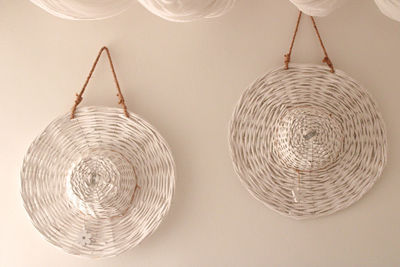 Low angle view of illuminated pendant lights hanging on ceiling