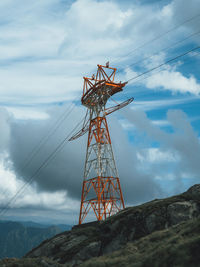 Low angle view of communications tower against sky