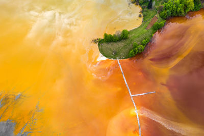 Lake polluted with yellow waste water, aerial view of mining decanting pond  from copper mine