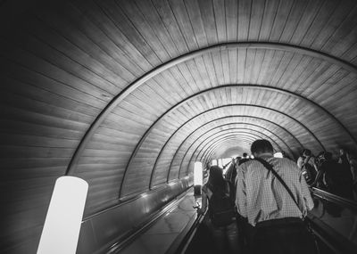 Rear view of people walking in subway station