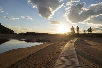 Scenic view of beach against sky during sunset