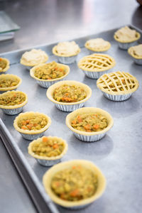 High angle view of tartlets in baking sheet