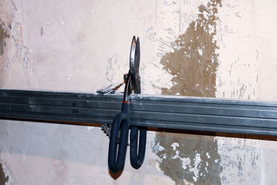 Close-up of motorcycle on snow against wall