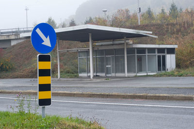 Road sign by street in city