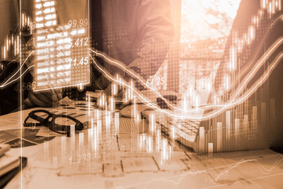 Digital composite image of glass window on table in illuminated building