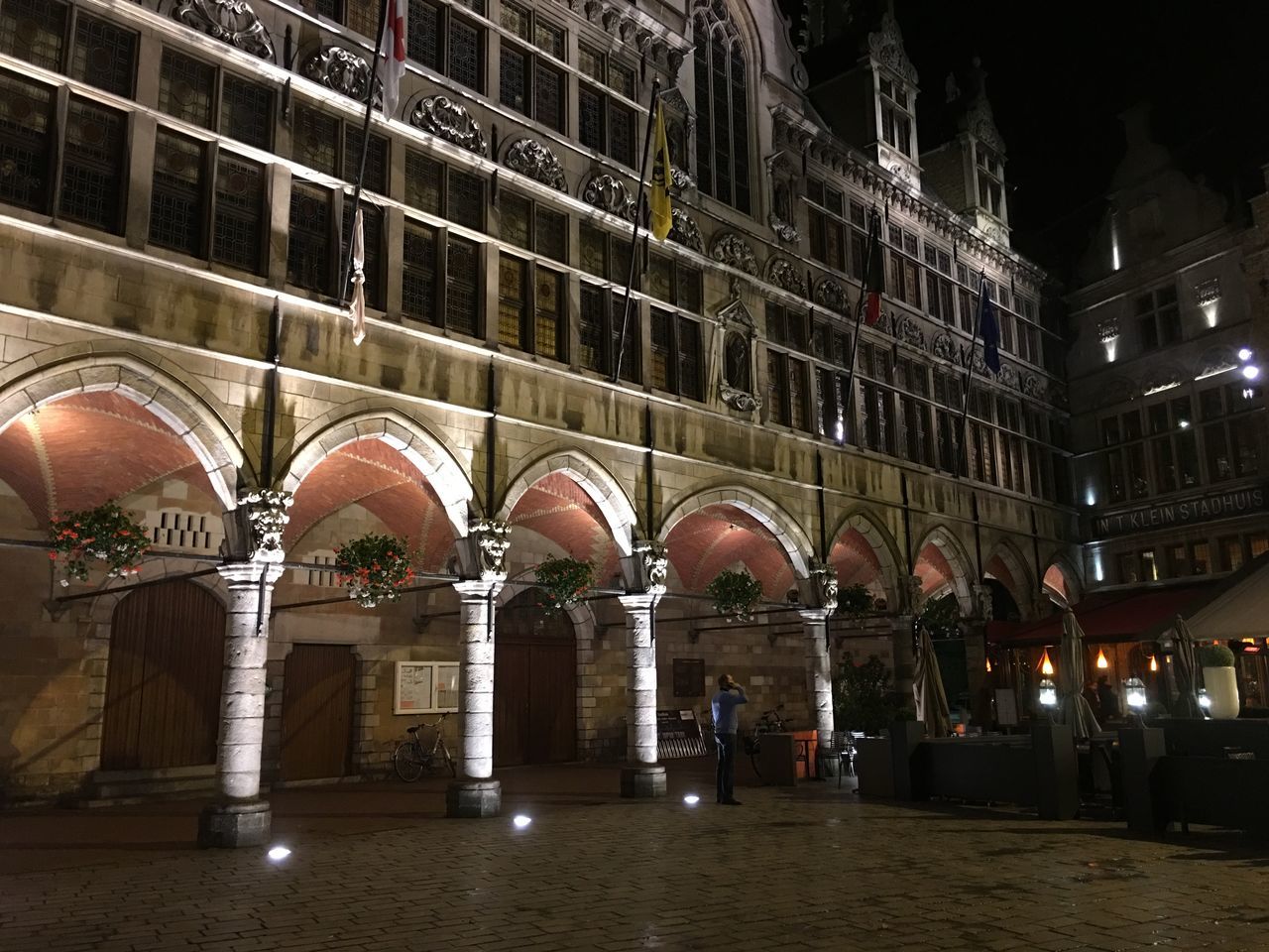 architecture, built structure, night, building exterior, illuminated, arch, window, low angle view, building, facade, history, lighting equipment, city, street light, no people, outdoors, dark, residential building, architectural column, light - natural phenomenon