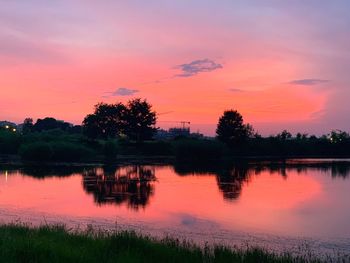 Scenic view of lake against romantic sky at sunset