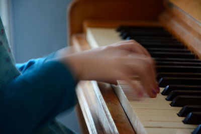 Close-up of person playing piano