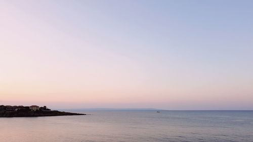 Scenic view of sea against clear sky during sunset