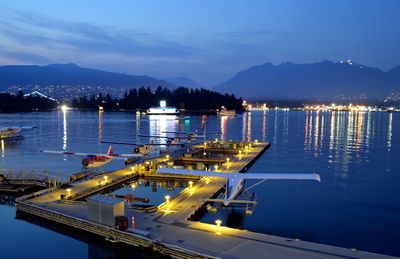 Boats in sea against sky at night