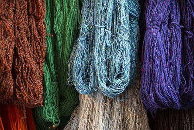 Full frame shot of multi colored threads hanging in store for sale