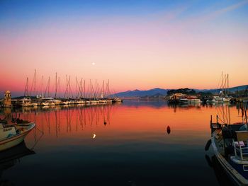 Boats in marina at sunset