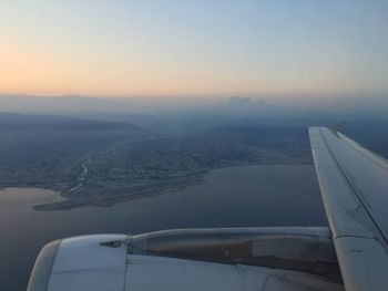 Cropped image of airplane flying over sea