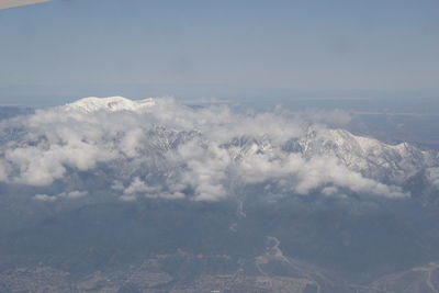 Aerial view of clouds over landscape against sky