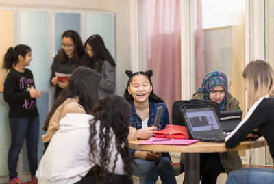 Teenage girls sitting together