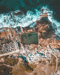 Aerial view of rock formations at sea