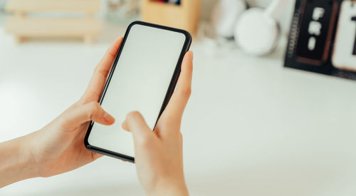 Midsection of man using mobile phone
