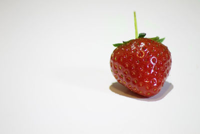 Close-up of strawberry over white background