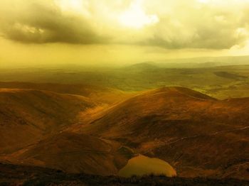 Aerial view of landscape against cloudy sky