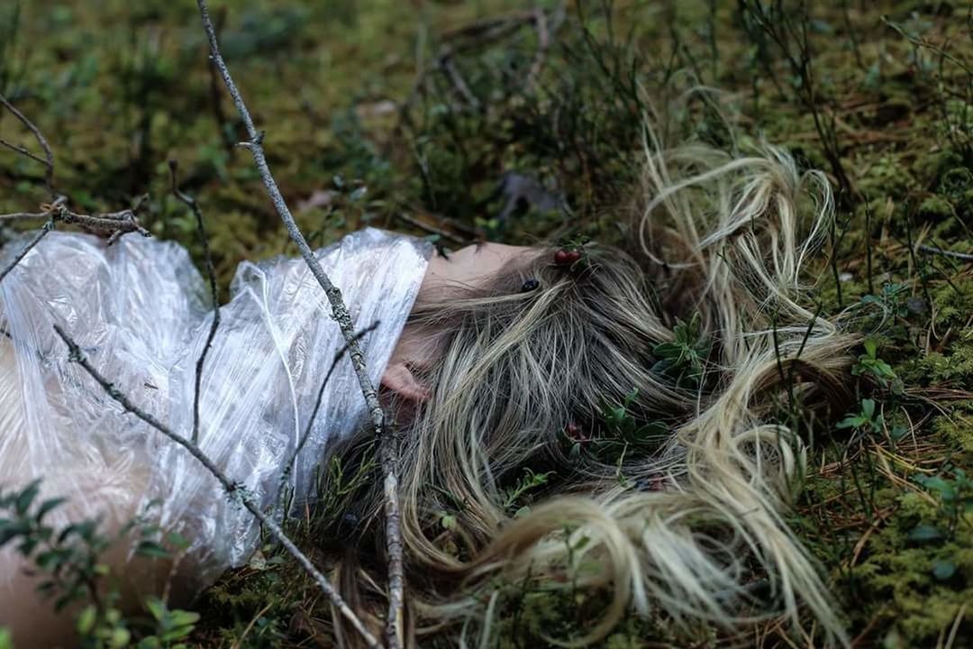 WOMAN LYING DOWN IN GRASS