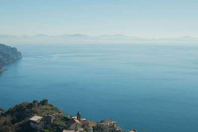 High angle view of sea and mountains against sky