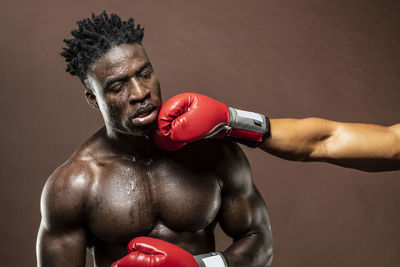 Boxers fighting against brown background