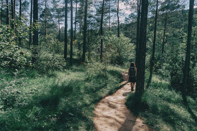 Woman walking along a small path in the mountain