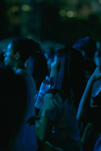 Side view of people enjoying at music concert