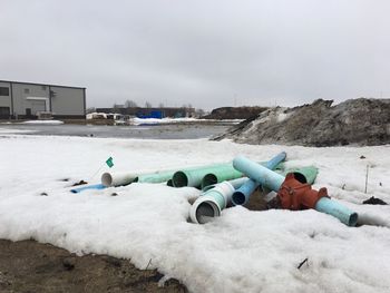 White lying on snow covered land against sky